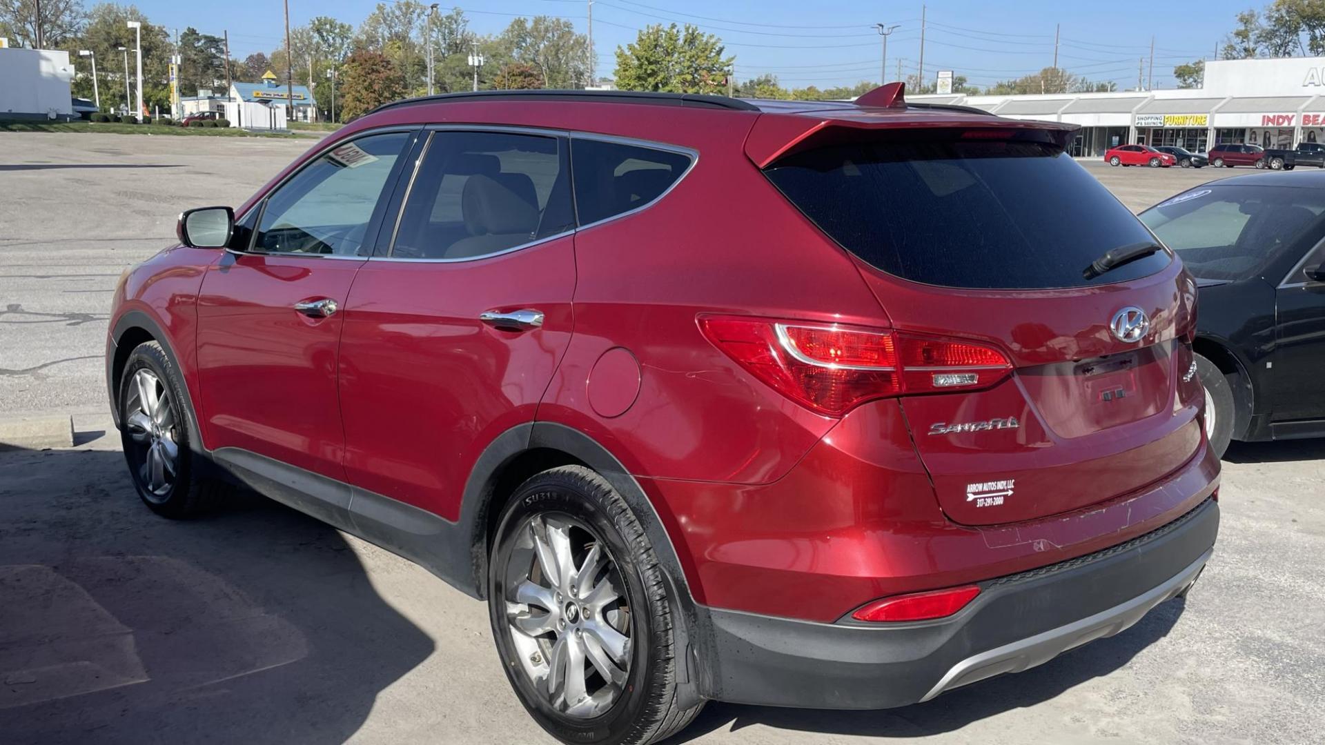 2013 MAROON Hyundai Santa Fe Sport 2.0 FWD (5XYZU3LAXDG) with an 2.0L L4 DOHC 16V engine, 6-Speed Automatic transmission, located at 2710A Westlane Rd., Indianapolis, IN, 46268, (317) 291-2000, 39.885670, -86.208160 - Photo#3