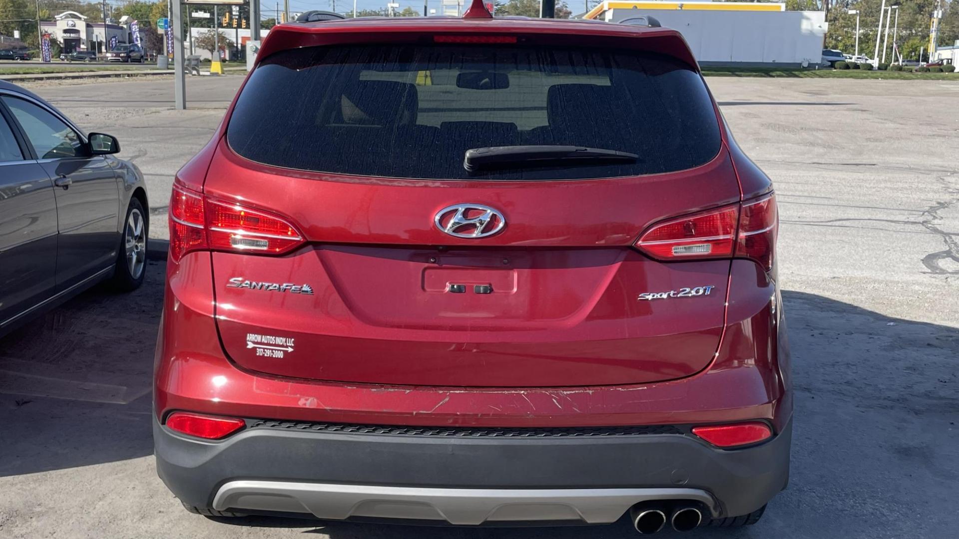 2013 MAROON Hyundai Santa Fe Sport 2.0 FWD (5XYZU3LAXDG) with an 2.0L L4 DOHC 16V engine, 6-Speed Automatic transmission, located at 2710A Westlane Rd., Indianapolis, IN, 46268, (317) 291-2000, 39.885670, -86.208160 - Photo#5