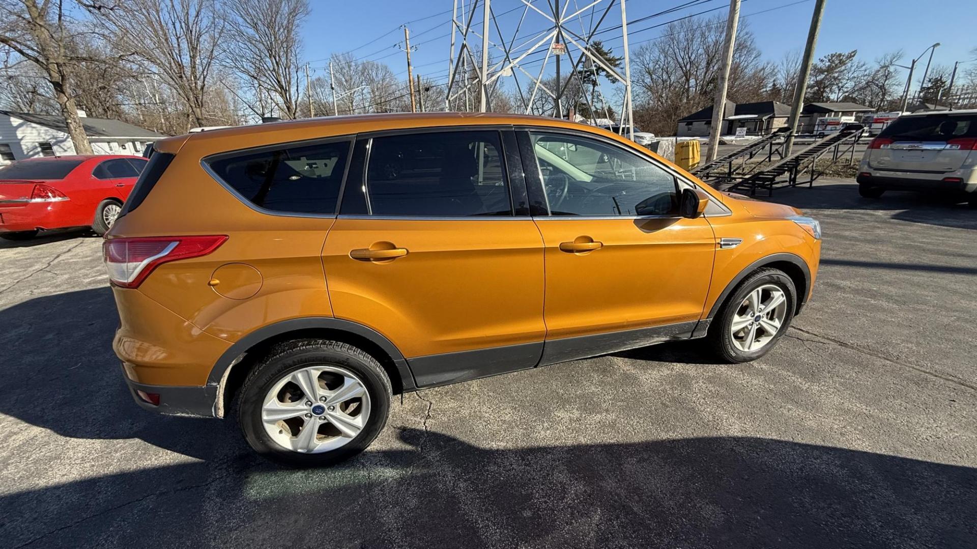 2016 ORANGE/COPPER /GRAY Ford Escape SE 4WD (1FMCU9GX1GU) with an 1.6L L4 DOHC 16V engine, 6-Speed Automatic transmission, located at 2710A Westlane Rd., Indianapolis, IN, 46268, (317) 291-2000, 39.885670, -86.208160 - Photo#2