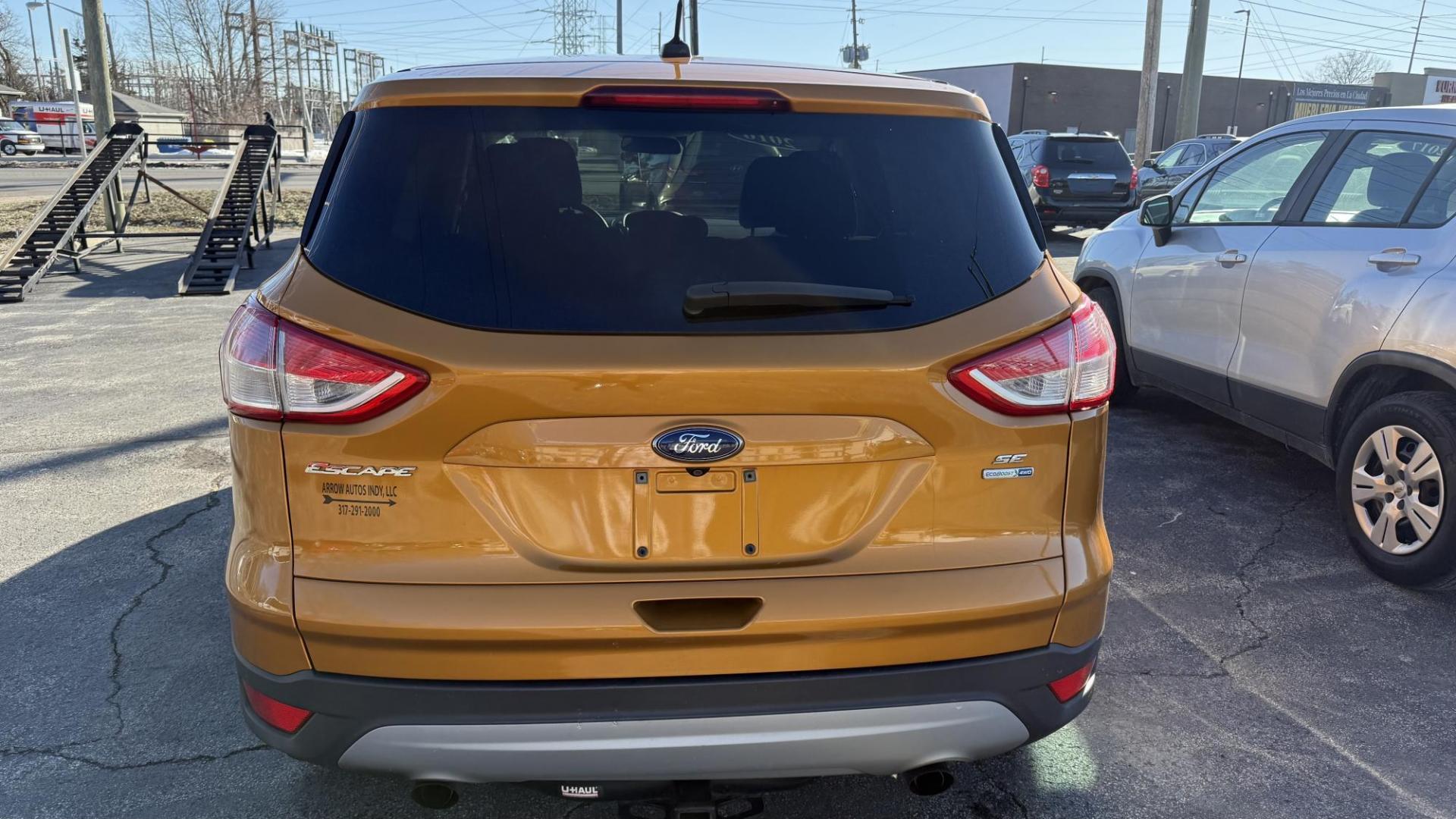 2016 ORANGE/COPPER /GRAY Ford Escape SE 4WD (1FMCU9GX1GU) with an 1.6L L4 DOHC 16V engine, 6-Speed Automatic transmission, located at 2710A Westlane Rd., Indianapolis, IN, 46268, (317) 291-2000, 39.885670, -86.208160 - Photo#6